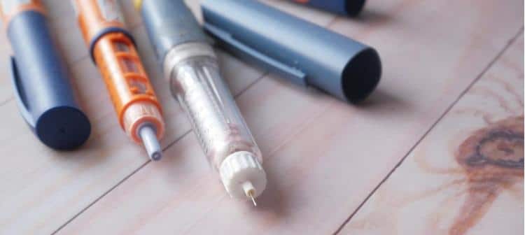 Professional-Healthcare-Provider-Demonstrating-Insulin-Pen-Needle-Injection-Technique-To-Diabetes-Patient