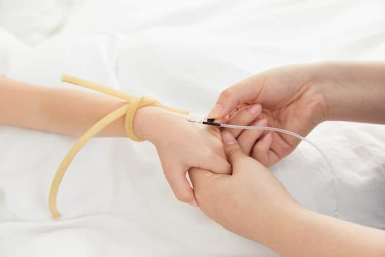 healthcare-professional-performing-venipuncture-butterfly-needle-patient-care-clinical-setting