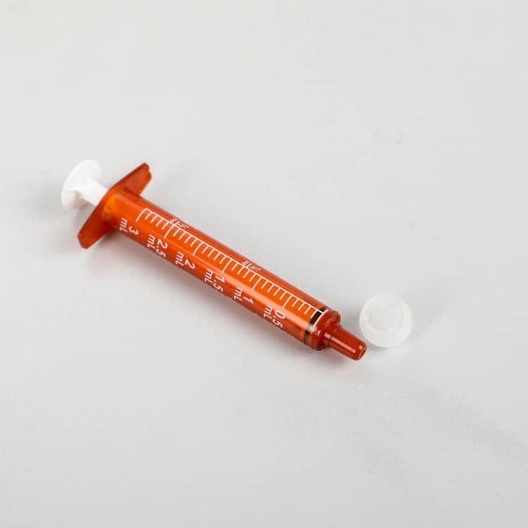 home-healthcare-family-caregiver-using-oral-syringe-for-medication-administration