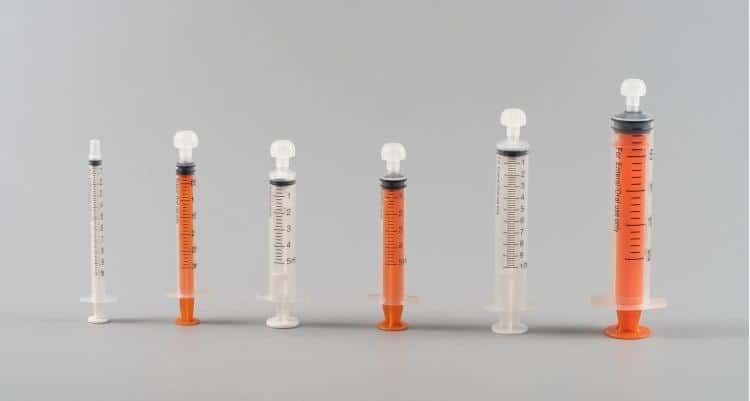 healthcare-professional-demonstrating-proper-oral-syringe-medication-administration-technique-to-elderly-patient