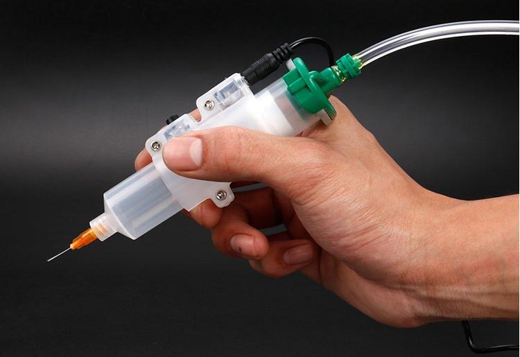 industrial-application-worker-using-specialized-custom-syringes-for-electronic-dispensing