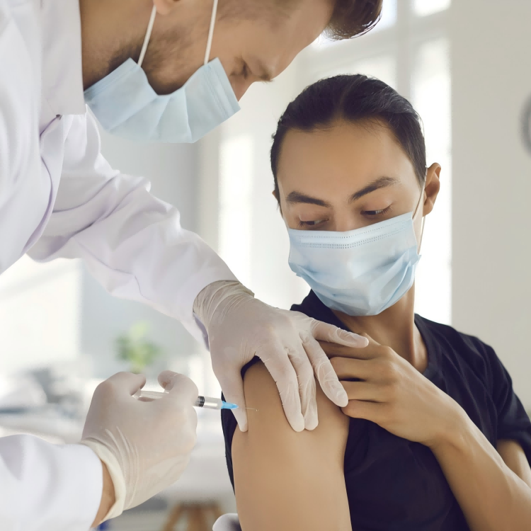 nurse-administering-vaccine-injection-with-disposable-medical-syringe-to-patient