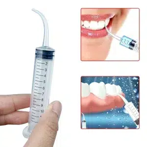 Dental syringe in use for surgical site irrigation and post-operative care application
