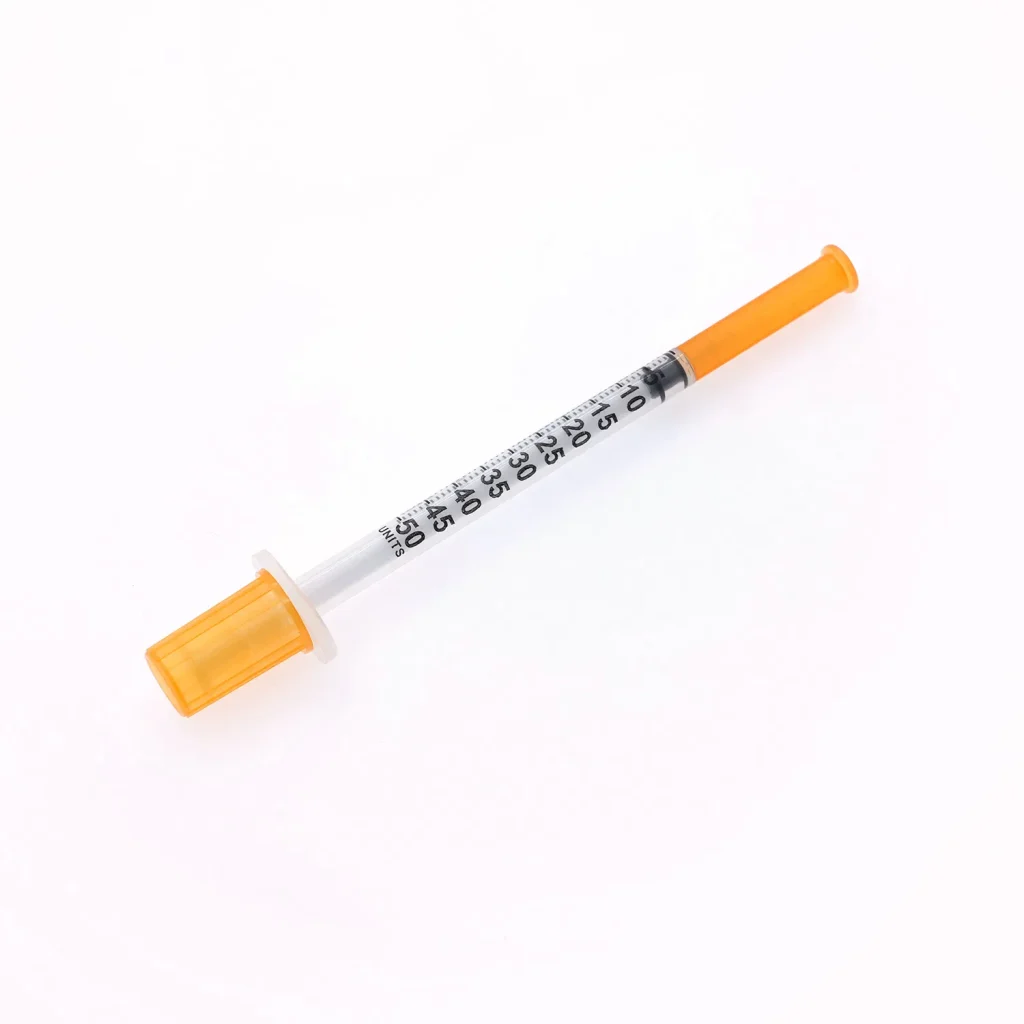 Medical grade insulin syringe with orange identification cap showing precise graduated measurements and ultra-fine needle