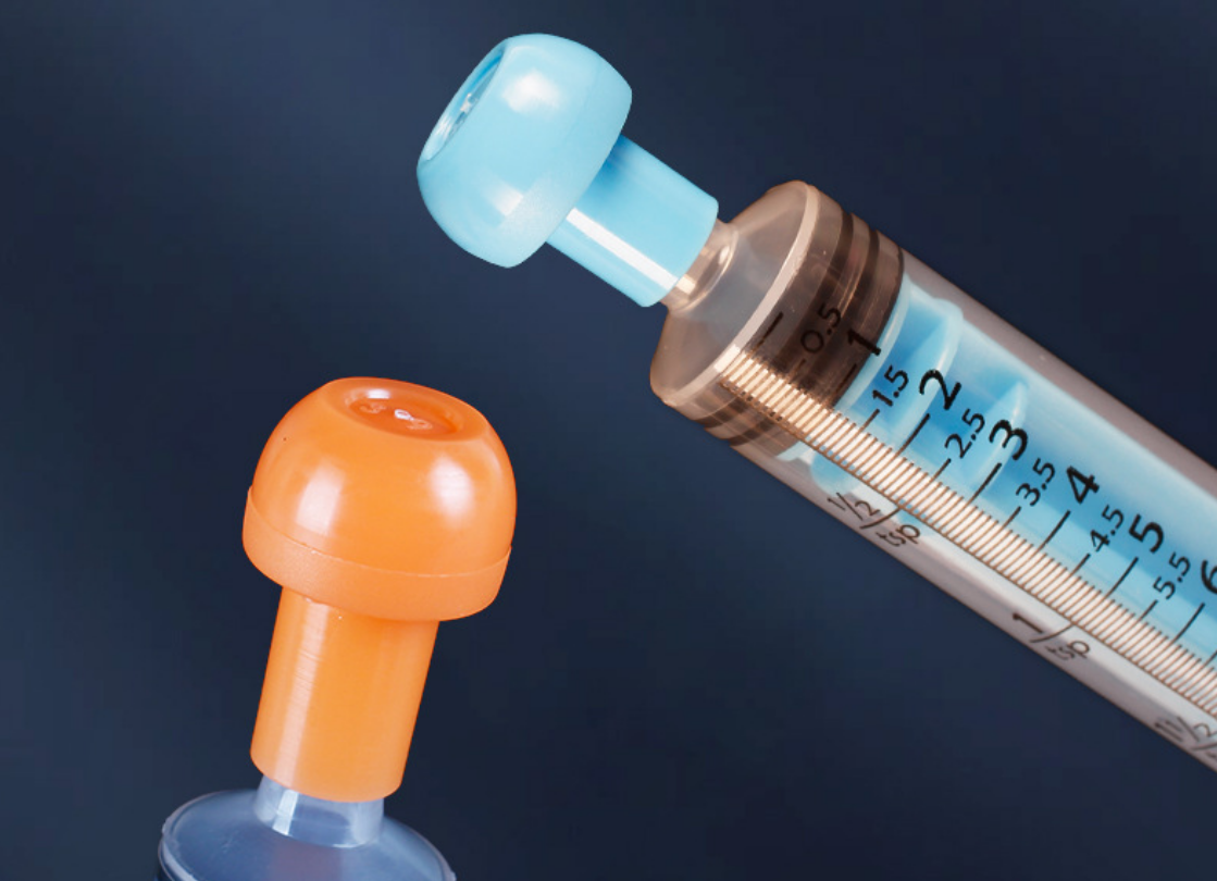 Close-up detail of feeding syringe smooth nozzle tip designed for safe gentle liquid administration to pets