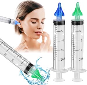 Private ear syringe being used for safe home ear wax removal and ear irrigation by adult user