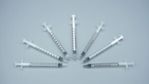 Top view of bulk set of 1ml no needle individually wrapped sterile syringes